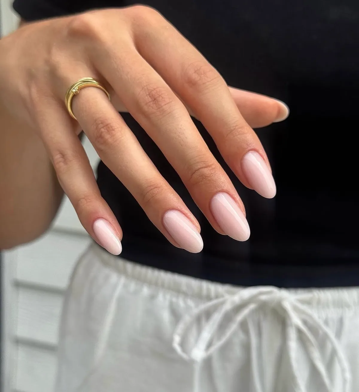 Zachtroze gelnagels met een gouden ring
